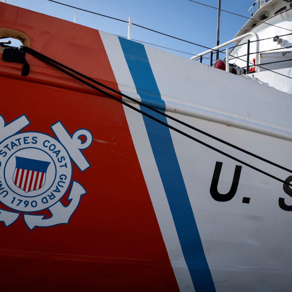 U.S. Coast Guard vessel monitoring an oil tanker during a maritime sanctions enforcement operation in the Caribbean Sea
