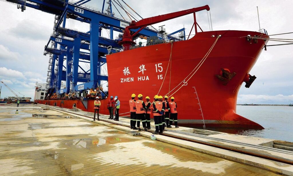 Chinese cargo ship Zhen Hua 29 carrying giant port cranes on a long international voyage.