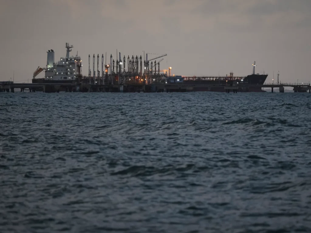 Cargo oil tanker at sea representing rising geopolitical and compliance risks in global freight shipping.