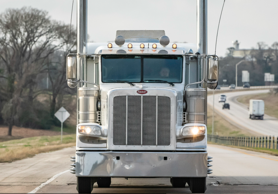 Commercial semi-truck operating on U.S. highway amid new non-domiciled CDL regulations by FMCSA