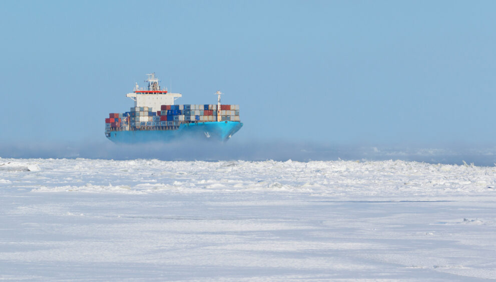 Container ship navigating through Arctic waters along the Northern Sea Route during ice-free season